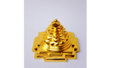 Gold-colored decorative item on a white background